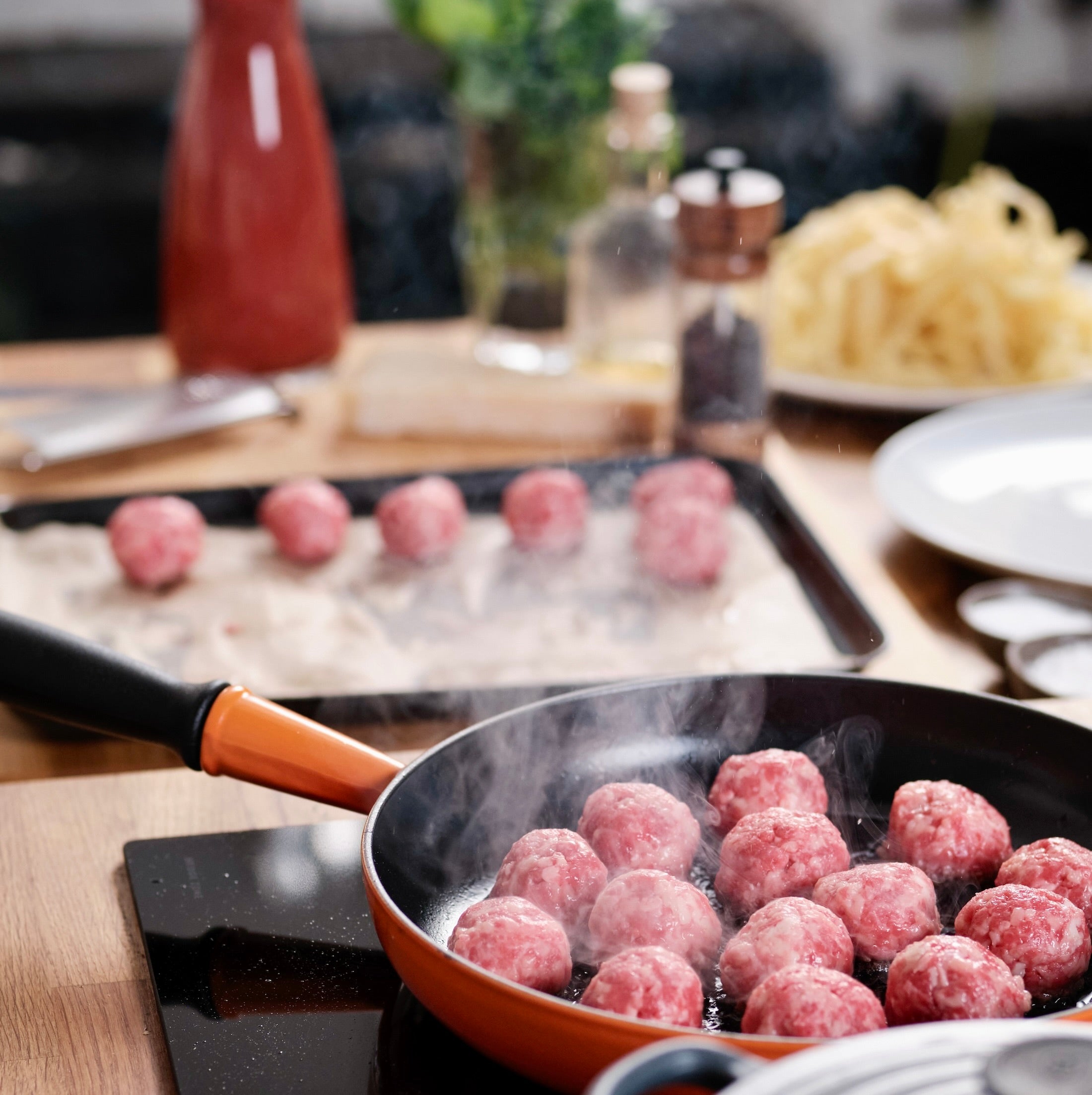 meat balls using mince being cooked in a pan