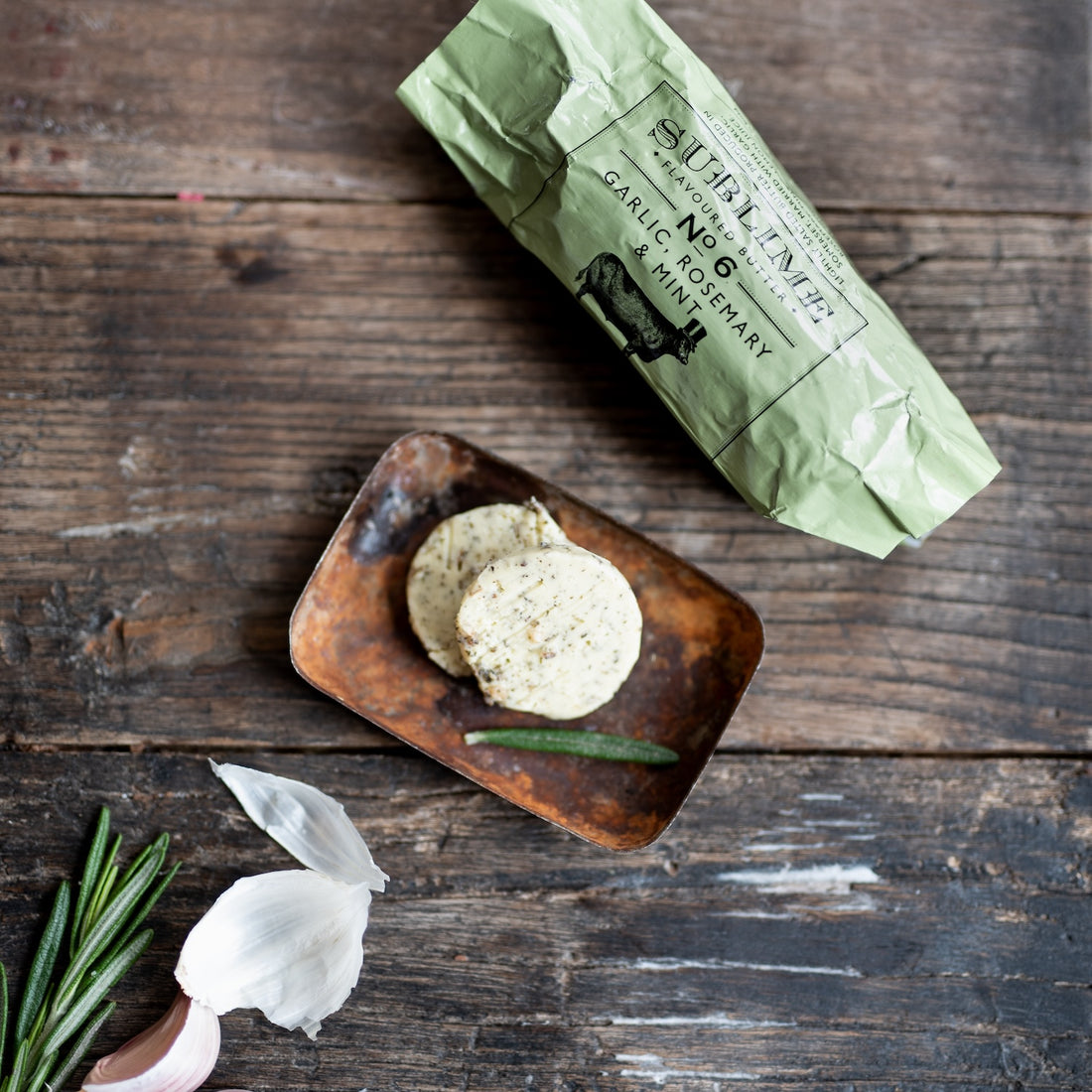 slices of garlic, rosemary and mint flavoured butter by sublime butter